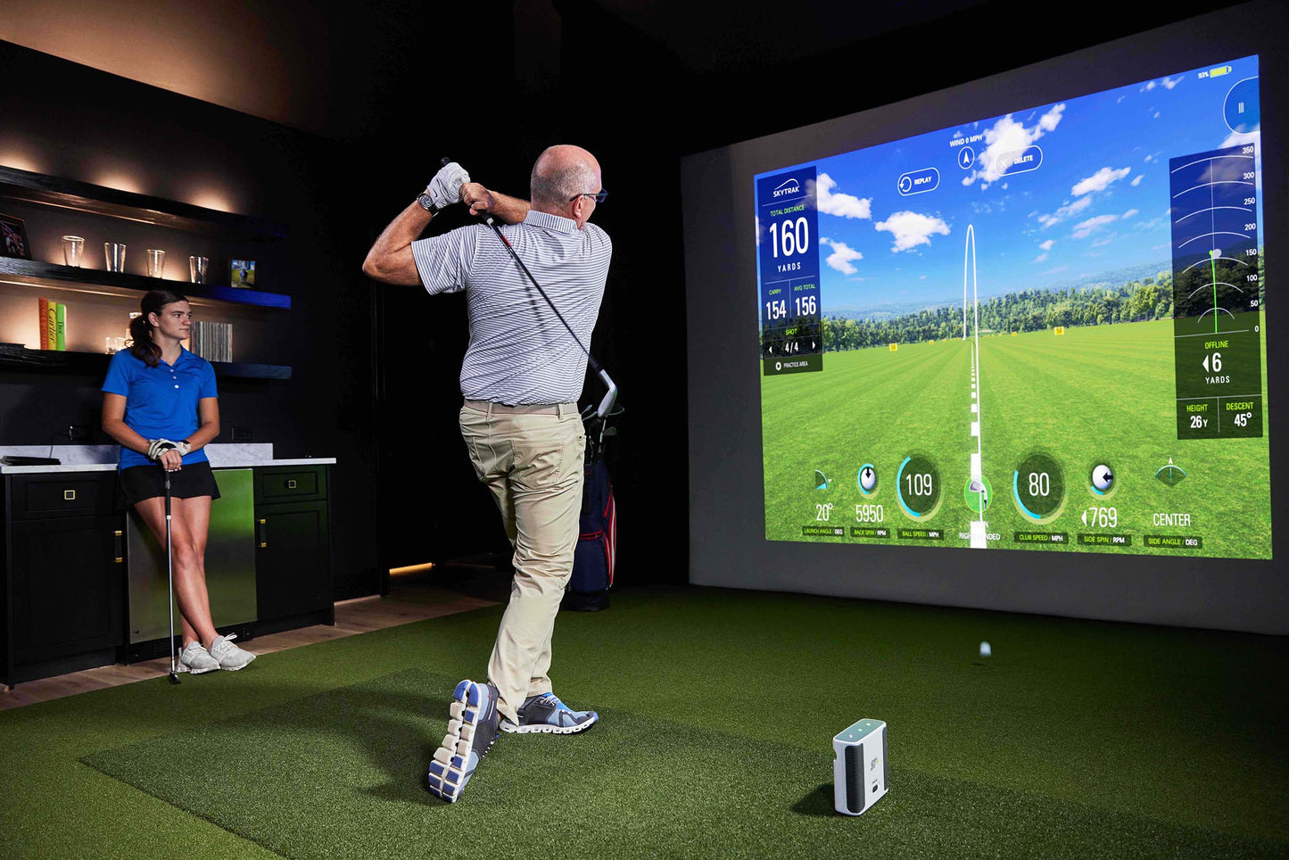 SkyTrak+ Indoor Simulator with Two Golfers