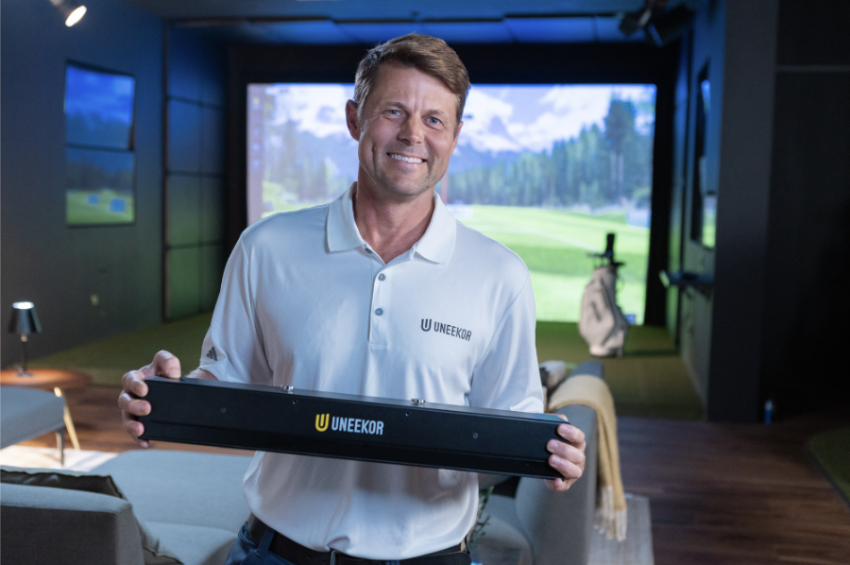 Golfer Holding Uneekor Eye XR Launch Monitor