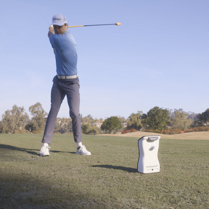 Golfer On Range Using QuadMax Swing Speed Trainer