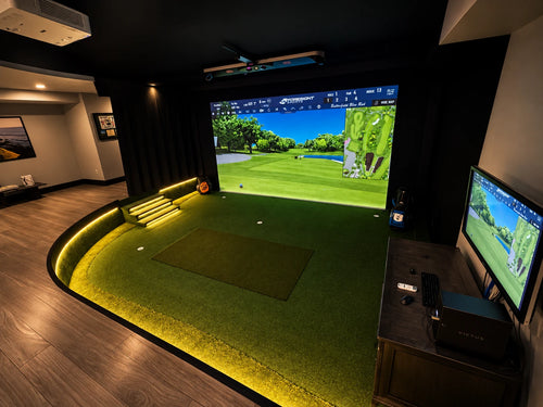 Step down, dug out basement golf simulator with custom lighting around the edge.