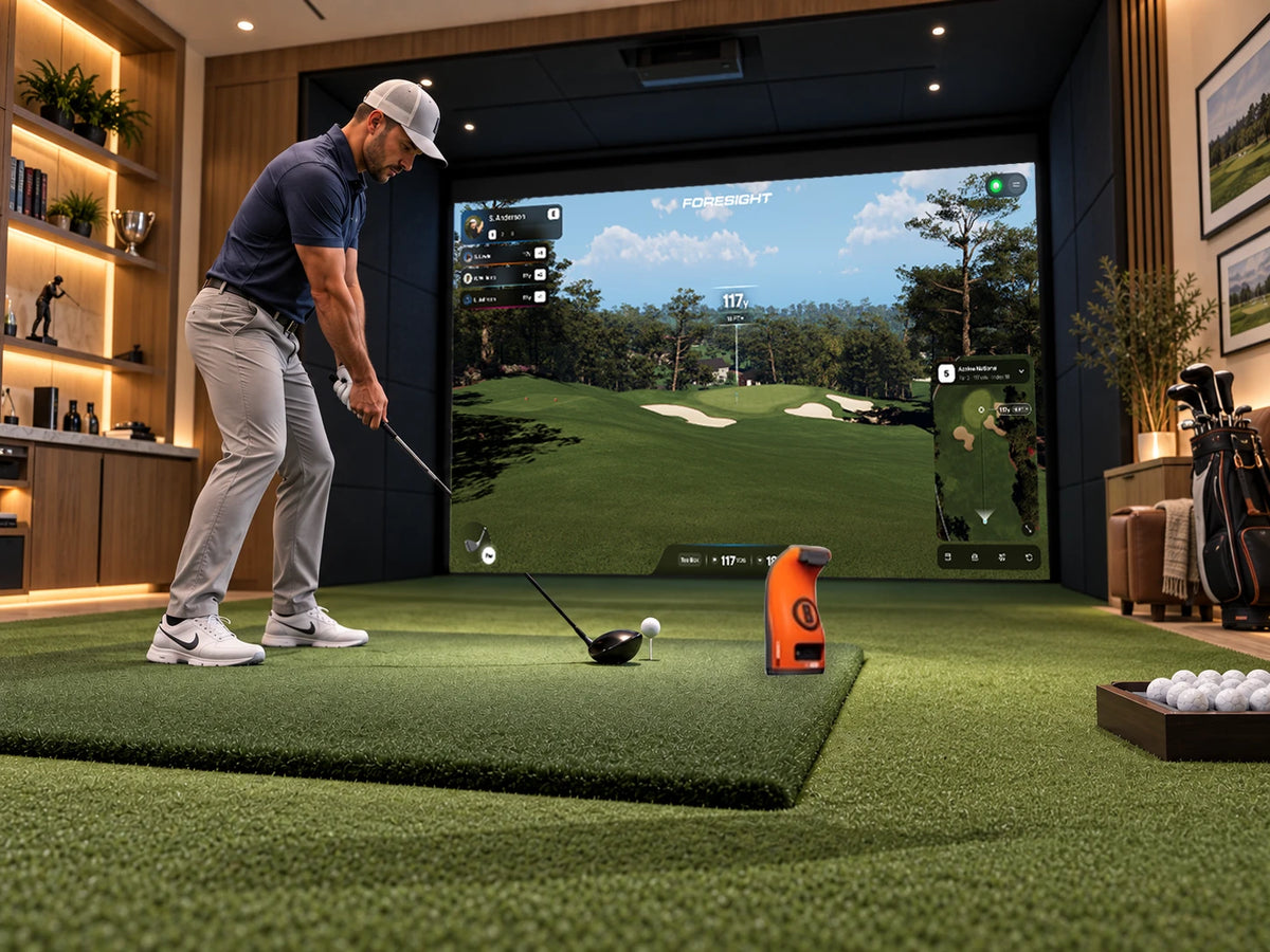 Bushnell Launch Pro Circle B Indoor Golf Simulator Room with Foresight Premier course play software on the screen and the Circle B monitor on the floor in front of the golfer