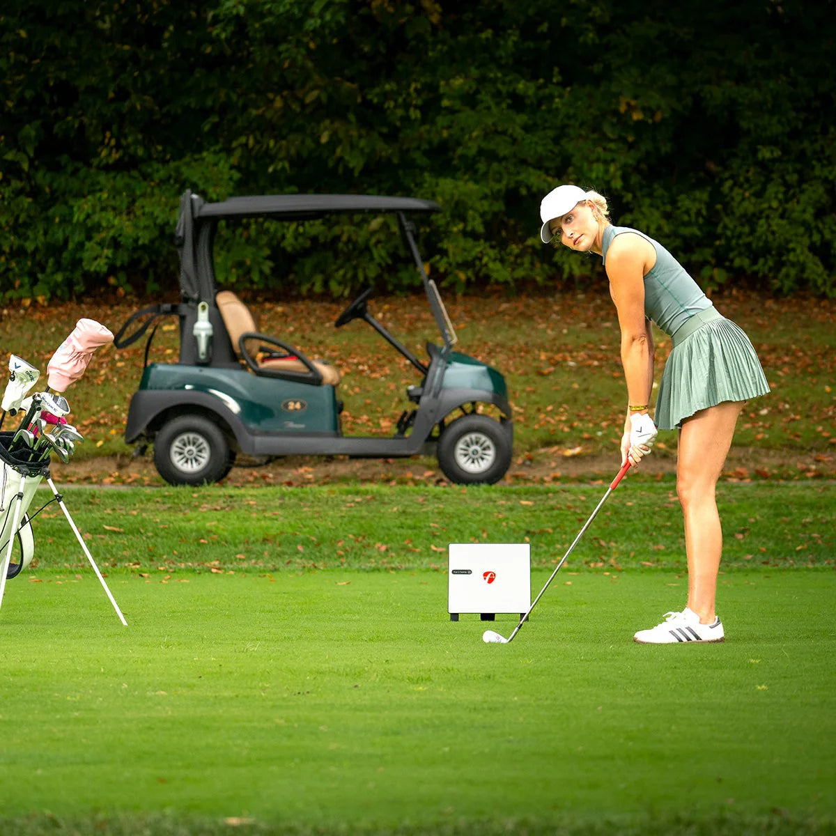 Golfer on tee hitting with FlightScope X3C behind her