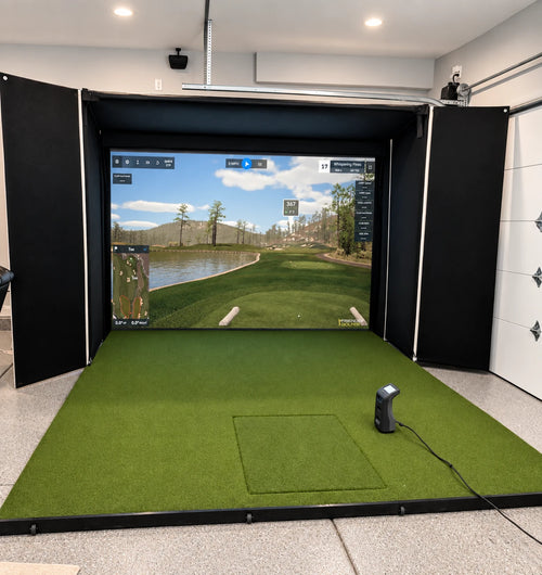 Murphy retractable golf simulator opened in a garage with GSPro on the screen and a GC3 launch monitor.