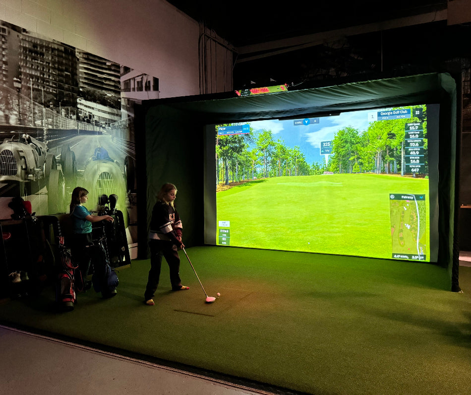 The Sport Screen 16' Golf Enclosure with golfers hitting