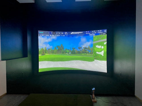 Curved Screen Golf Simulator In A Dark Room